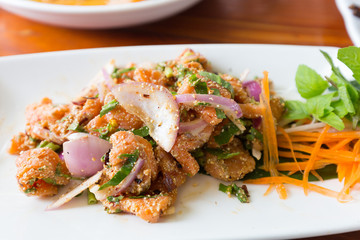 Spicy salmon salad and vegetable on white dish