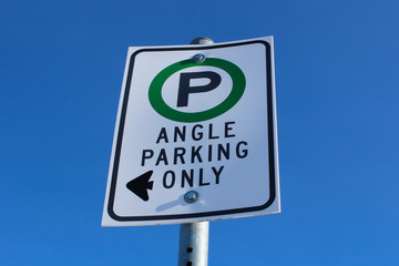 Angle Parking Only Sign Against Blue Sky