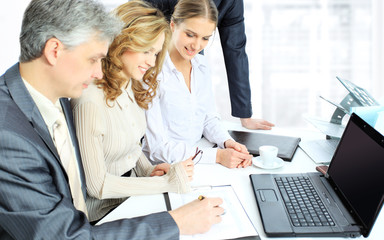 Fototapeta premium Business partners are discussing a plan of cooperation against the background of team work in office