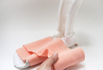 isolated woman hold bandage roll with splint in white background