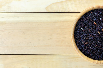 riceberry with wooden spoon on wooden background