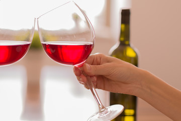 Celebrating by clinking glasses of red wine

