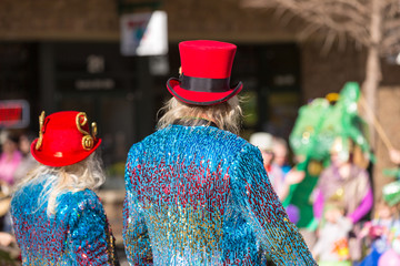Couple With Red Top Hats And Sequined Suits In A Parade