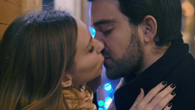 man and woman overwhelmed by the passion in the street: passionate kisses