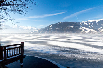 Frozen lake Zeller and snowy mountains in Austria