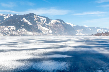 Frozen lake Zeller and snowy mountains in Austria