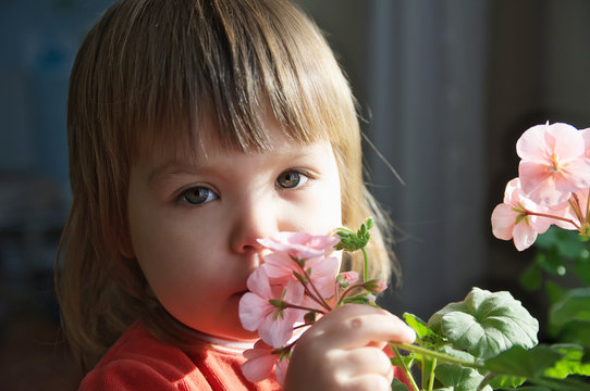Child portrait with spring flowers, kid feeling happiness,joyful people without spring allergy