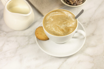 Coffee with milk, butter cookie and milk jar