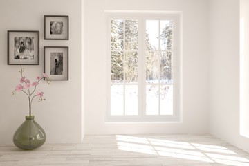 White empty room with vase and winter landscape in window. Scandinavian interior design