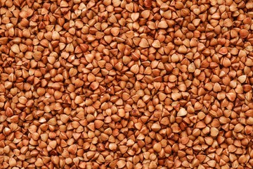 buckwheat grains background, roasted groats in market