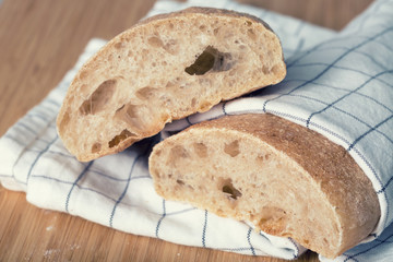 A homemade ciabatta bread on a wooden table