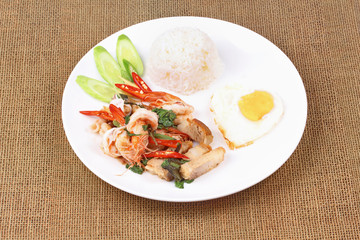 Jasmine rice topped stir - fried spicy basil with meat.