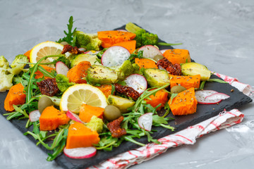 Steamed sweet potato, broccoli and other vegetables salad on slate. Love for a healthy vegan food concept