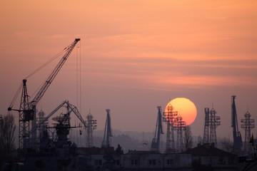 Industrial port dockyard with sunset