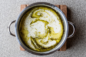 Turkish Yayla or Yogurt Soup with mint sauce in pan / Tzatziki.