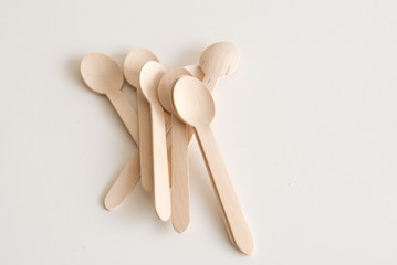 High angle view of bamboo spoons in a pile on white table