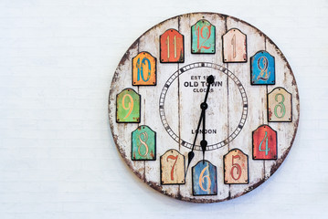 Vintage clock on white wall.