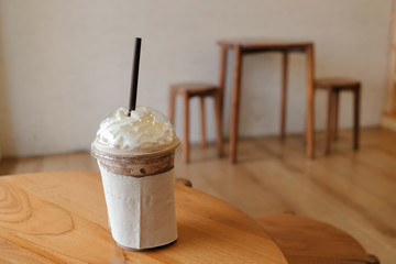 Coffee Frappe on wooden table in coffee shop.