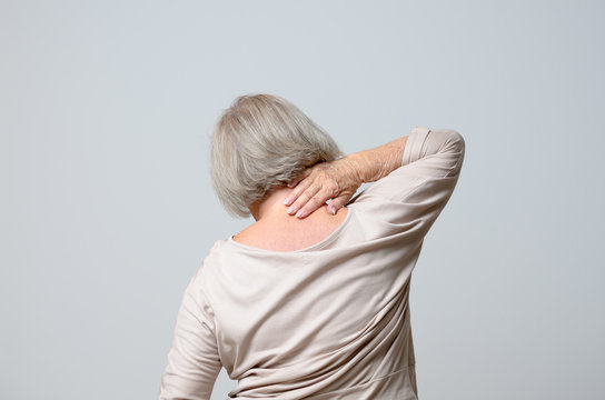Senior woman touching her neck