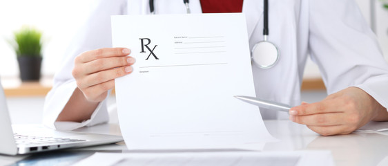 Female medicine doctor hand hold clipboard pad and give prescription to patient closeup. Panacea and life save, prescribe treatment, legal drug store, contraception concept © rogerphoto