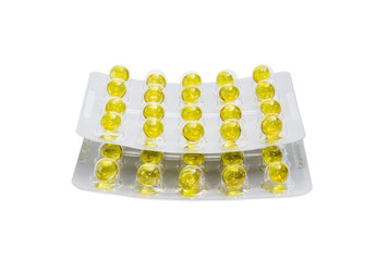 Blister packs with yellow pills on a light background