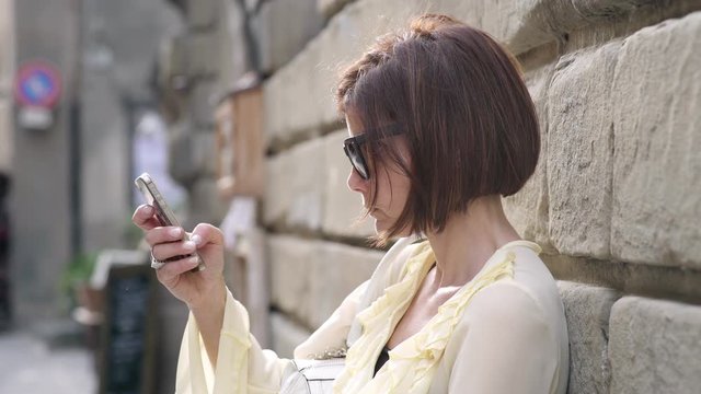Profile of charming woman using smartphone
