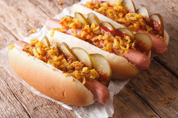 Fresh Danish hot dogs with crispy onions and pickles close up. horizontal