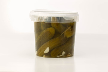 Pickled cucumbers in jar isolated on white background
