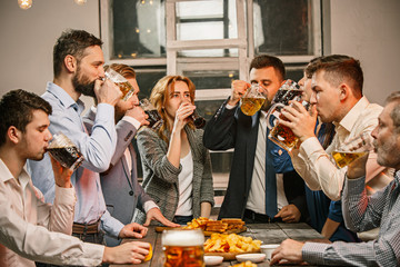 Group of friends enjoying evening drinks with beer
