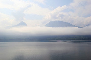 Travel to Sankt-Wolfgang, Austria. The view on the lake Wolfgangsee near to mountains in the cloudy weather.