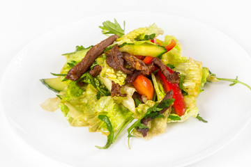 Plate of fresh vegetables salad with meat isolated at white background.