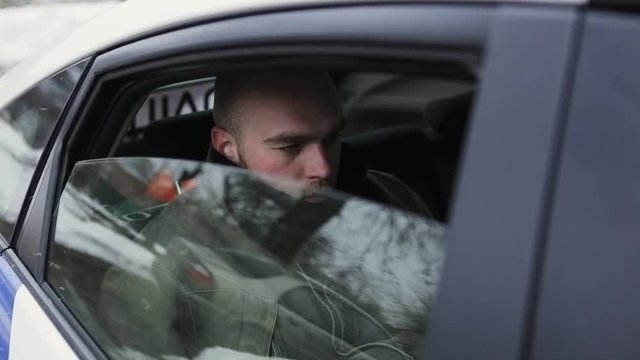 The Malefactor is Sitting In a Police Car. Man caught police officers and sat in the car