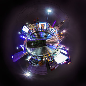 Night skyline of Warsaw with soviet era Palace of Culture and science. 360 degree panoramic montage as tiny planet