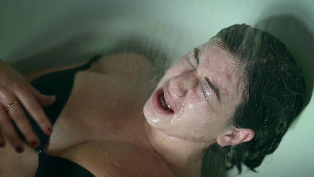 abused , depressed woman screaming under the shower