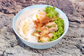 Japanese rice topped boil eggs and fried pork.
