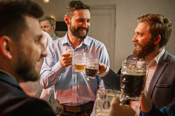 Group of friends enjoying evening drinks with beer