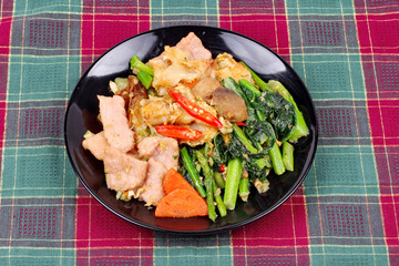 Fried big noodle topped mixed vegetables for organic food.