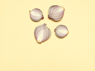 Red onion on a yellow background