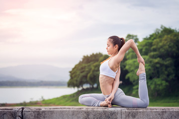 Naklejka na ściany i meble Asia woman doing yoga fitness exercise
