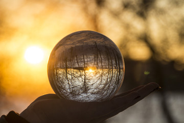 Sunset in the winter through a glass sphere