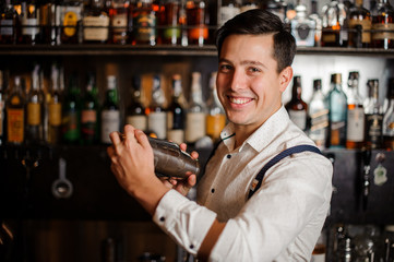 smiling bartender shaking coctail