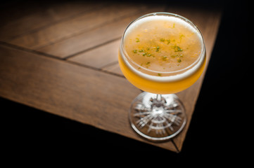 orange coctail on the brown table