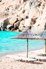 Beach wooden chairs and umbrellas for vacations on beach in Greece