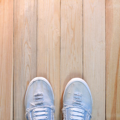 Sneaker canvas shoe on wooden floor.  Life Style conception.