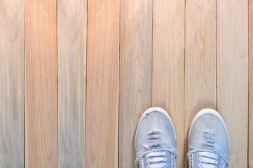 Sneaker canvas shoe on wooden floor.  Life Style conception.