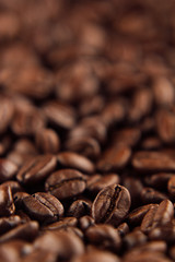 Roasted coffee beans close-up with blur vertical shot as background.