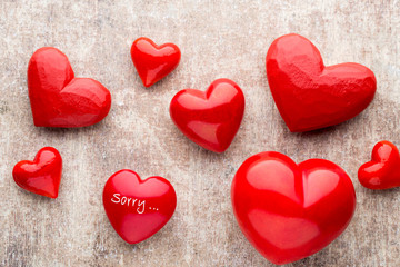 Red heart on the wooden background.