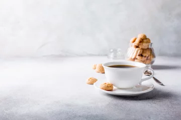 Poster White cup of coffee with amaretti cookies on light gray background with copy space. © Iryna Melnyk