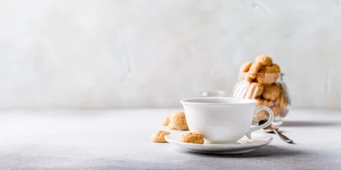 Foto auf Acrylglas White cup of coffee with amaretti cookies on light gray background with copy space. © Iryna Melnyk