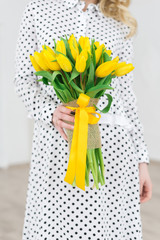 Happy woman with yellow tulips